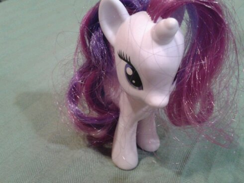 Rarity stands on super-table at the Roving Imp